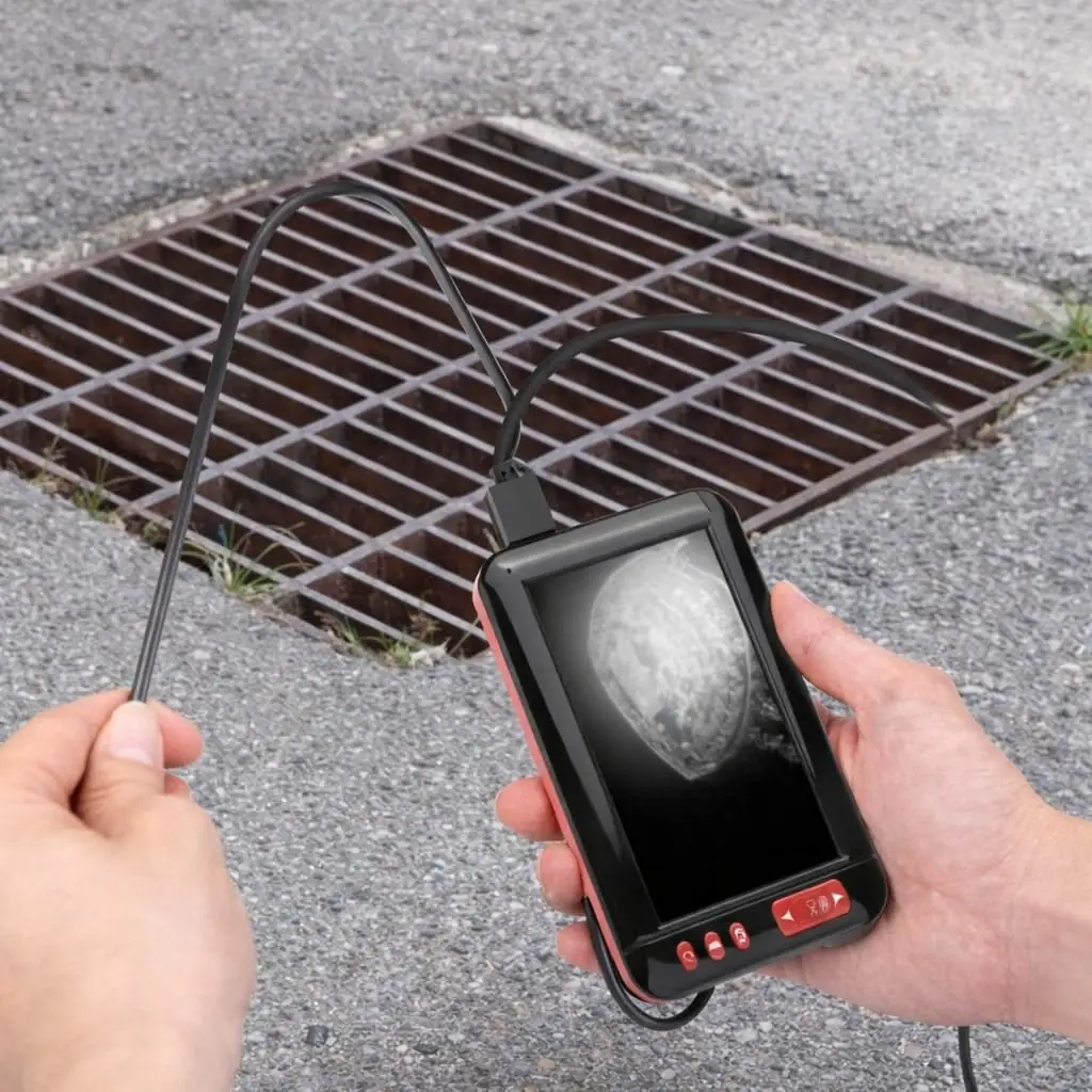 Inspection camera checking hidden pipes and wall cavities